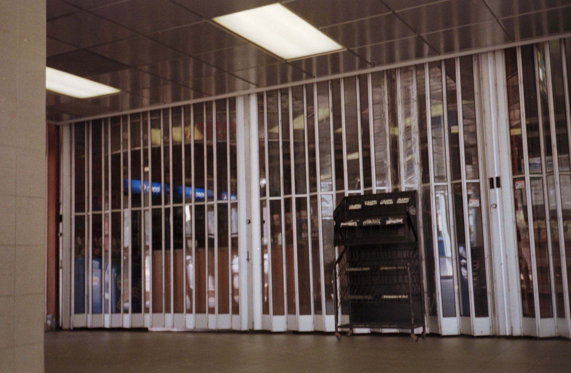 Closed security gate in a hallway with mail holder